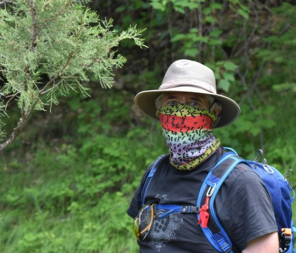 Man with a bandana tied around his nose and mouth.